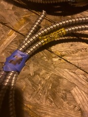 About 12ft of flexible metal conduit with wire inside