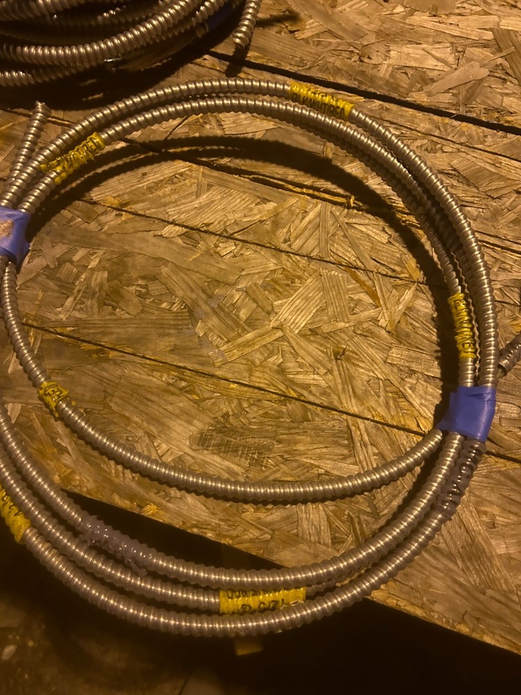 About 12ft of flexible metal conduit with wire inside