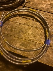 About 12ft of flexible metal conduit with wire inside
