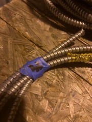 About 12ft of flexible metal conduit with wire inside